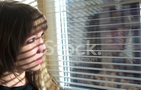 Sad Girl Looking Through Window Stock Photo Royalty Free Freeimages