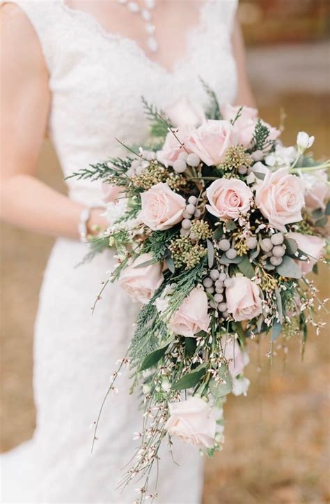 this blush pink rose cascading bridal bouquet with evergreens genestra stock and silver