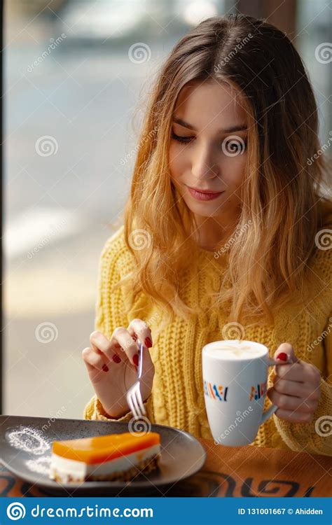 Young Woman Enjoying A Cup Of Coffee And A Slice Of Delicious Ca Stock