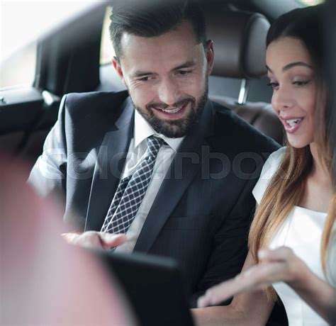 Smiling Business People Working In Backseat Of Car Stock Image