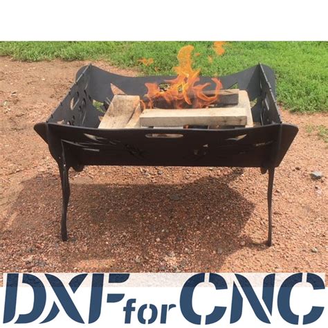 A Metal Fire Pit Sitting On Top Of A Dirt Field