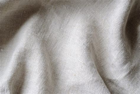 Soft Folds Of A Natural Woven Linen Fabric In Close Up Detail In A Full
