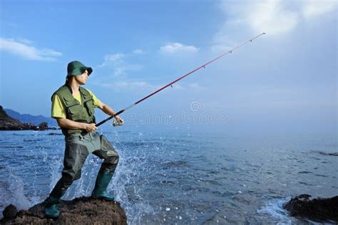 A Fisherman Fishing At The Sea Stock Photos Image 14825593