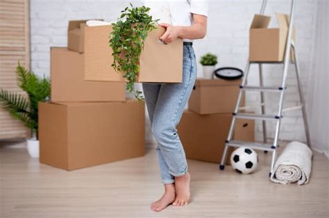 Premium Photo Young Woman With Cardboard Boxes Ready To Moving Day