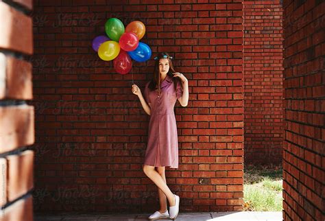 blonde girl posing against brick walls by stocksy contributor atakan erkut uzun stocksy