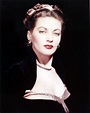 an old photo of a woman in a black dress and red lipstick on her lips