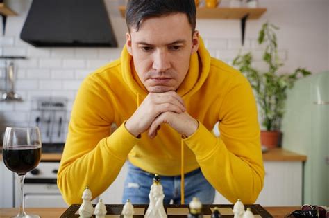Premium Photo Young Man Playing Chess On Kitchen Table Male Plays In