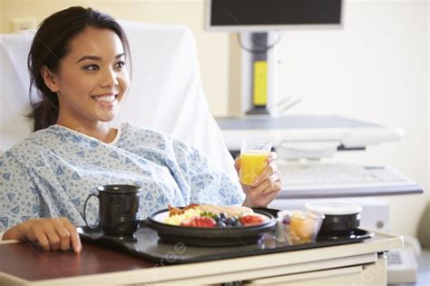Female Patient Enjoying Meal In Hospital Bed Background And Picture For