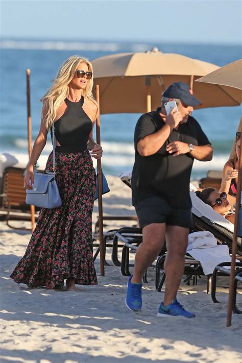 Victoria Silvstedt Wears A Black Halterneck Swimsuit With A Floral