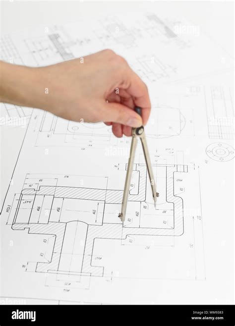 Hand Of The Engineer With Compasses Work With Drawings Stock Photo