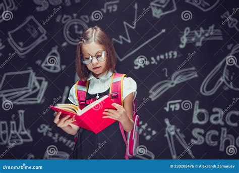 Serious Schoolgirl In Glasses Preparing To Go To School With Backpack