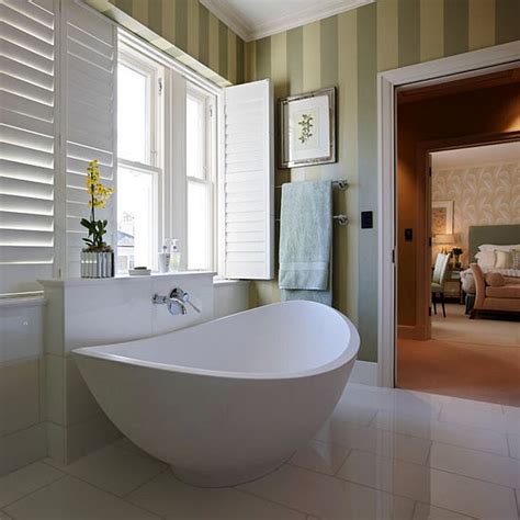 Small ensuite bathroom with white tiling laid in brick pattern. En Suite Bathroom Design Considerations