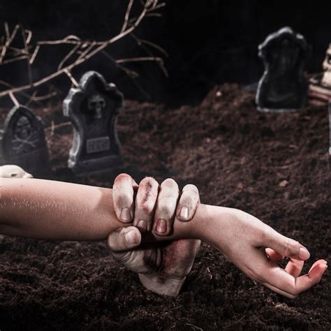 Free Photo Zombie Hand Holding Person Arm At Halloween Graveyard