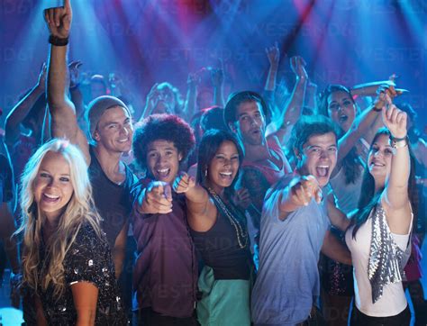 Portrait Of Enthusiastic Crowd On Dance Floor Of Nightclub Stock Photo