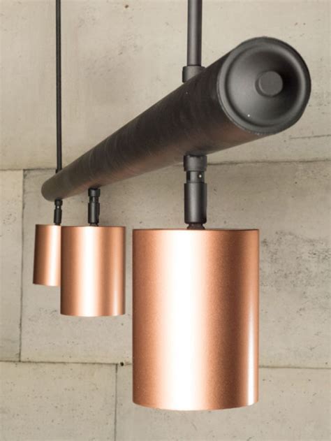 Copper Spotlights Hung From A Matt Black Bar Copper Lighting Track