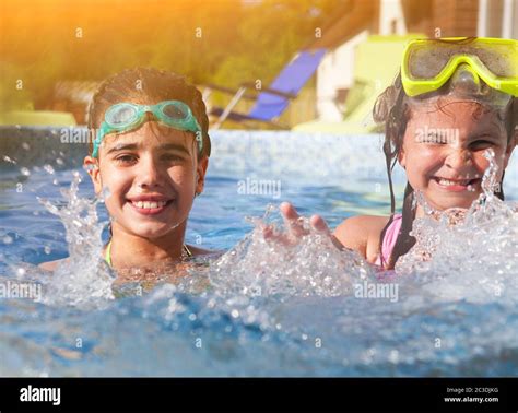 Two Cute Girls Playing In Swimming Pool Stock Photo Alamy