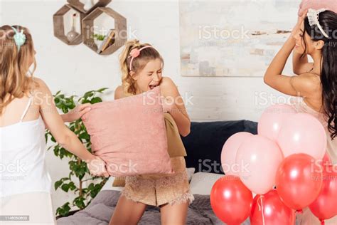 Beautiful Multiethnic Girls Having Fun And Fighting With Pillows During