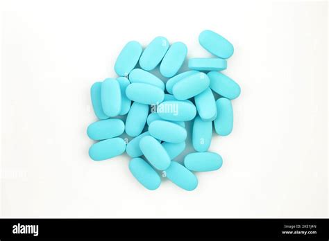 Pile of blue pills isolated on white background. Group of medications