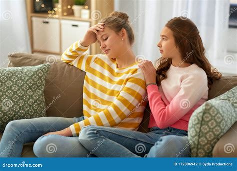Teenage Girl Comforting Her Sad Friend At Home Stock Photo Image Of