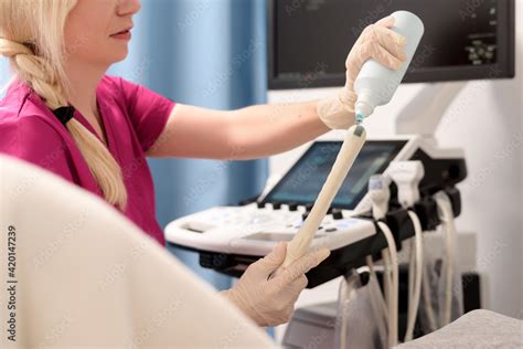 Gynecologist Applies Gel To A Transvaginal Ultrasound Scanner For A
