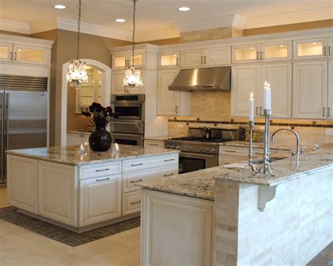 This farmhouse kitchen's black colour usage hits the design! Bianco Antico Granite Countertops White Cabinets