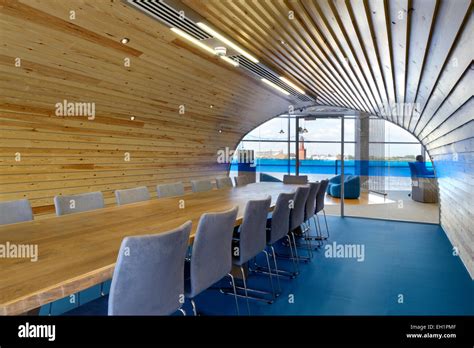 Wood Panelled Conference Room With Arched Ceiling And Blue Floor