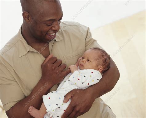 Man Holding Baby In Arms Stock Image C0521802 Science Photo Library