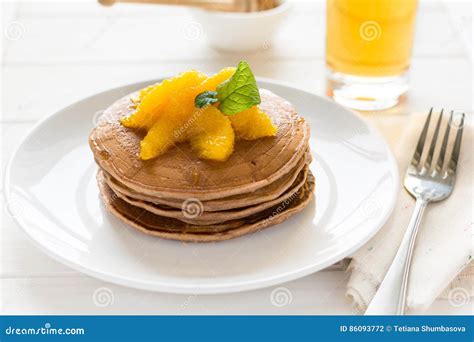 Traditional Breakfast Stack Of Pancakes With Orange Slices And Sweet