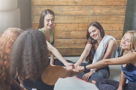Group Of Girls In Sportswear In Circle With United Hands Stock Photo