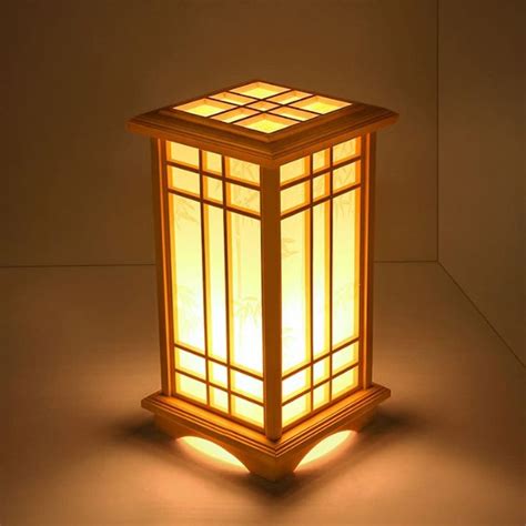 A Lamp That Is Lit Up In The Dark With Its Light Shining Down On It