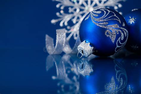 Blue And Silver Christmas Ornaments On Dark Blue Background Stock Photo
