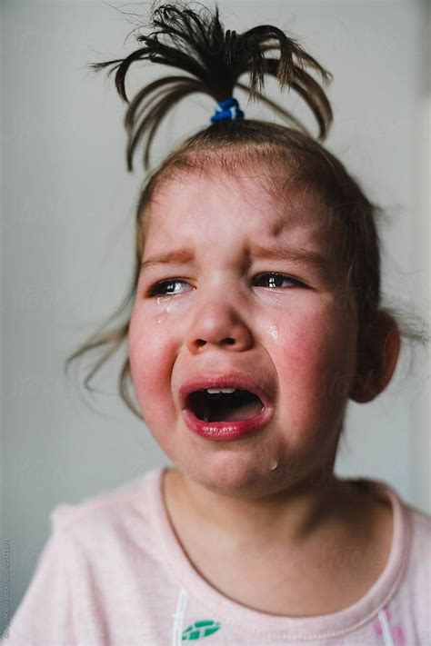 Crying Toddler Girl With Funny Topknot By Stocksy Contributor