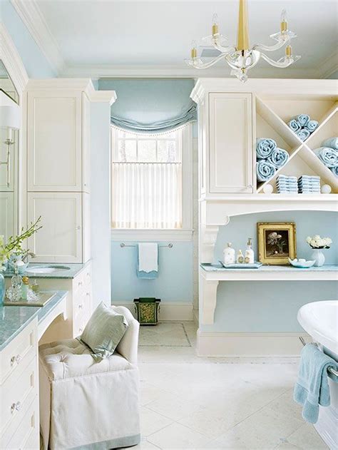 The design of the bathroom includes a vaulted ceiling that guides the eye up to the skylight, making the space feel large and open. Blue-and-White Cottage Bathroom Ideas | Open shelving ...