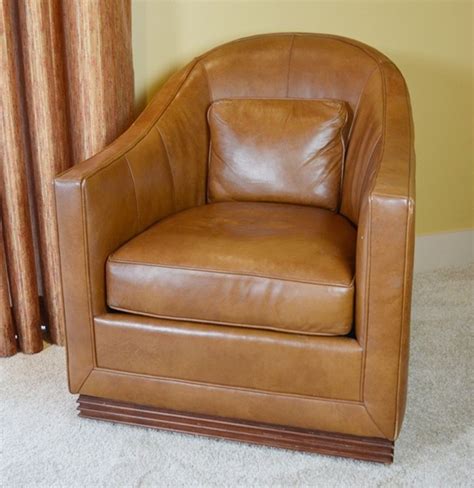 They usually have a padded backrest and cushioned armrests that cradle the body. Vanguard Furniture Caramel Leather Upholstered Swivel Club ...
