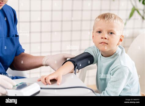Doctor Measuring Blood Pressure Of A Little Boy Diagnostic Healthcare