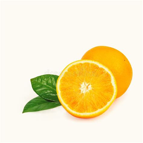 The Orange Is Isolated Whole Fruit And Half With Leaves On A White