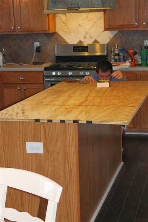We did all the work ourselves and bought ikea cabinets, and had planned to purchase three solid quartz countertops and get someone else to install them. The ragged wren : How-To: Faux Reclaimed Wood Counter Tops