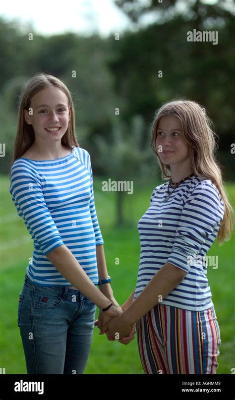 Teenage Girls Holding Hands Smiling Portrait Stock Photo Alamy