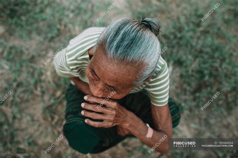 Nong Khiaw Laos From Above Shot Of Mature Local Woman Sitting On Ground Nature Lifestyle