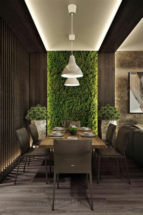 The Dining Room Is Decorated With Greenery And Modern Lighting