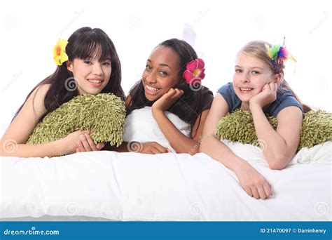 Slumber Party Young Women Together At Home Lying On Bed Looking Camera Happy Royalty Free Stock