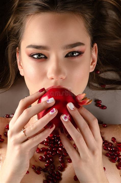 Beautiful Brunette Girl Eating Pomegranate From Above Stock Image