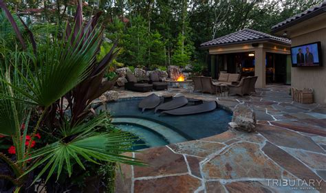 Built into the backyard is a giant pool and a $250,000 waterslide that goes from the master suite on the home's second level straight. TROPICAL OASIS - Tributary Pools & Spas