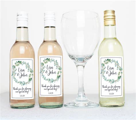 Three Bottles And Two Glasses With Labels On Them