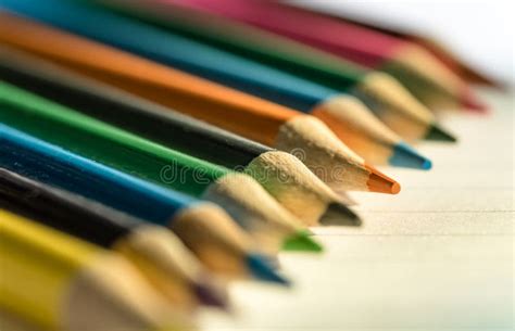 Coloured Pencils Seen On Writing Paper Seen Within A Classroom Stock