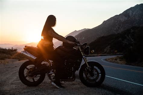 Woman Riding Motorcycle On Roadside · Free Stock Photo