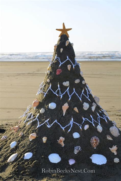 Sand Christmas Tree On The Beach Decorated With Lights And Shells