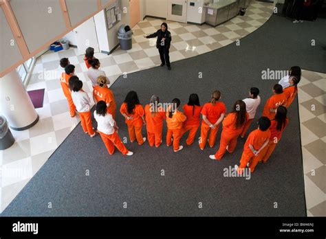 A Corrections Officer Addresses A Group Of Inmates In The Female Unit