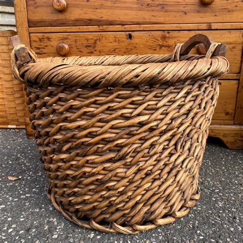 Sold A Large All Purpose Woven Wicker Basket With Wood Handles