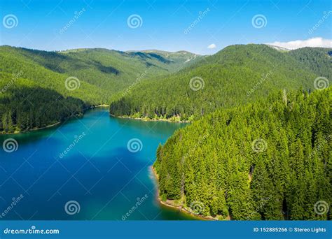 Mountain Lake With Turquoise Water And Green Trees Reflection In The